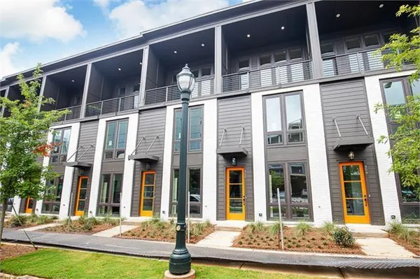 front view of a brick house with a yard