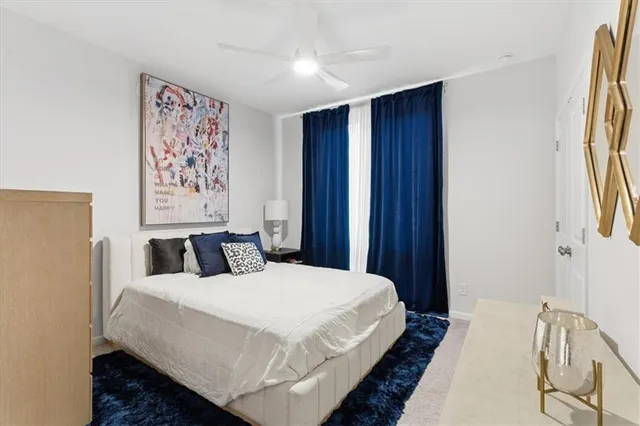 a bedroom with a bed and a painting on the wall