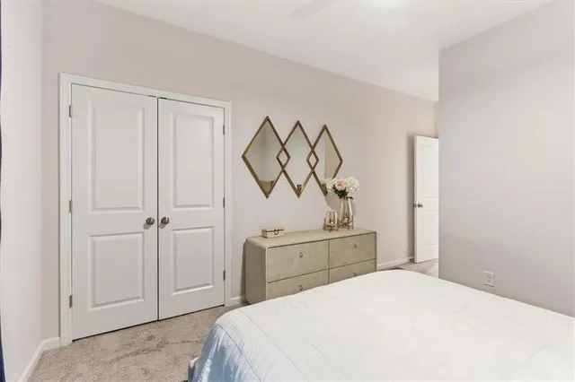 a bedroom with a bed and painting on the wall