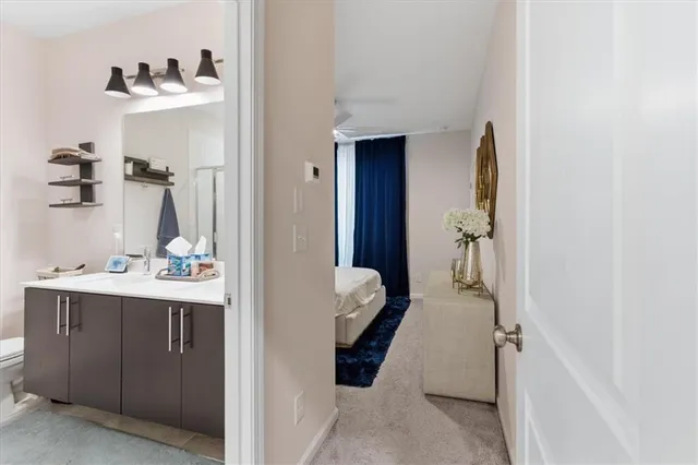 a bathroom with a sink and mirror with toilet
