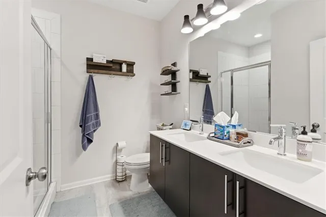 a bathroom with a double vanity sink mirror and toilet