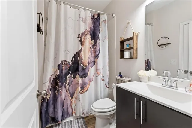 a bathroom with a sink toilet and shower