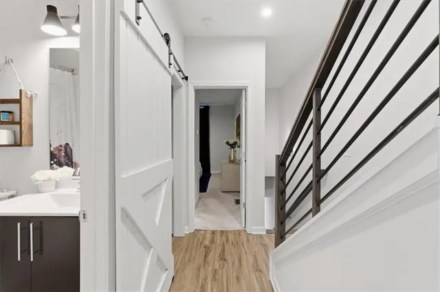 a view of a hallway with wooden floor and entryway