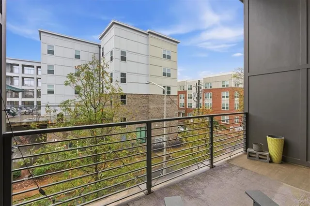 a view of a balcony with dining table and chairs