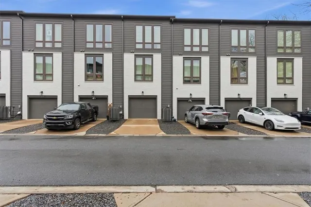 a view of a house with swimming pool and sitting area