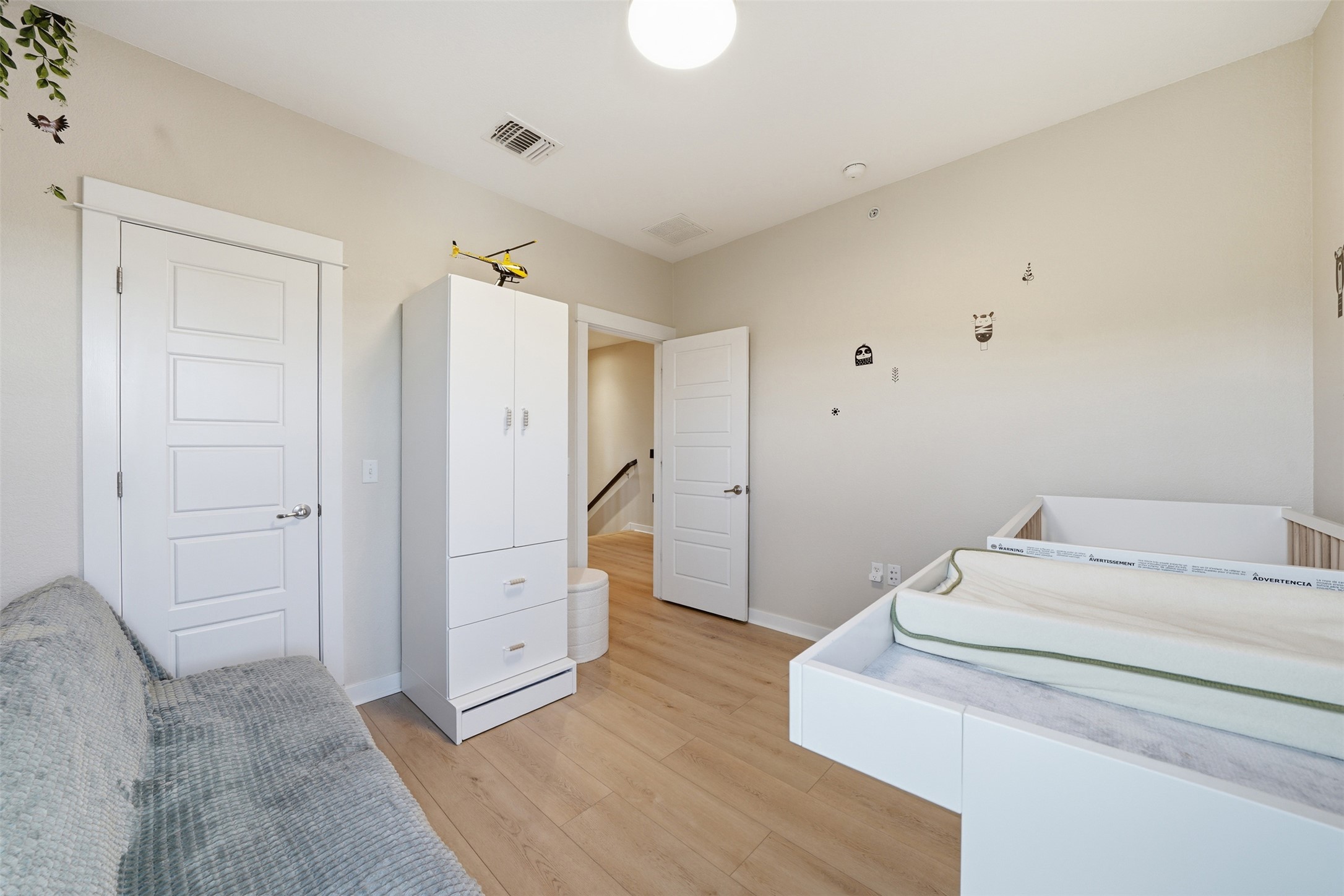 3901 Vaughan Street Austin, TX 78723 - Photo 18 of 37 Light wood-finish flooring provides a neutral foundation for this room, featuring light-toned walls and white trim