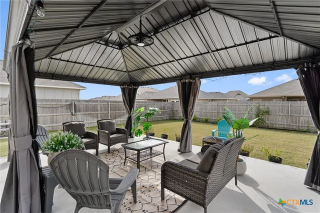 a view of an outdoor sitting area with furniture