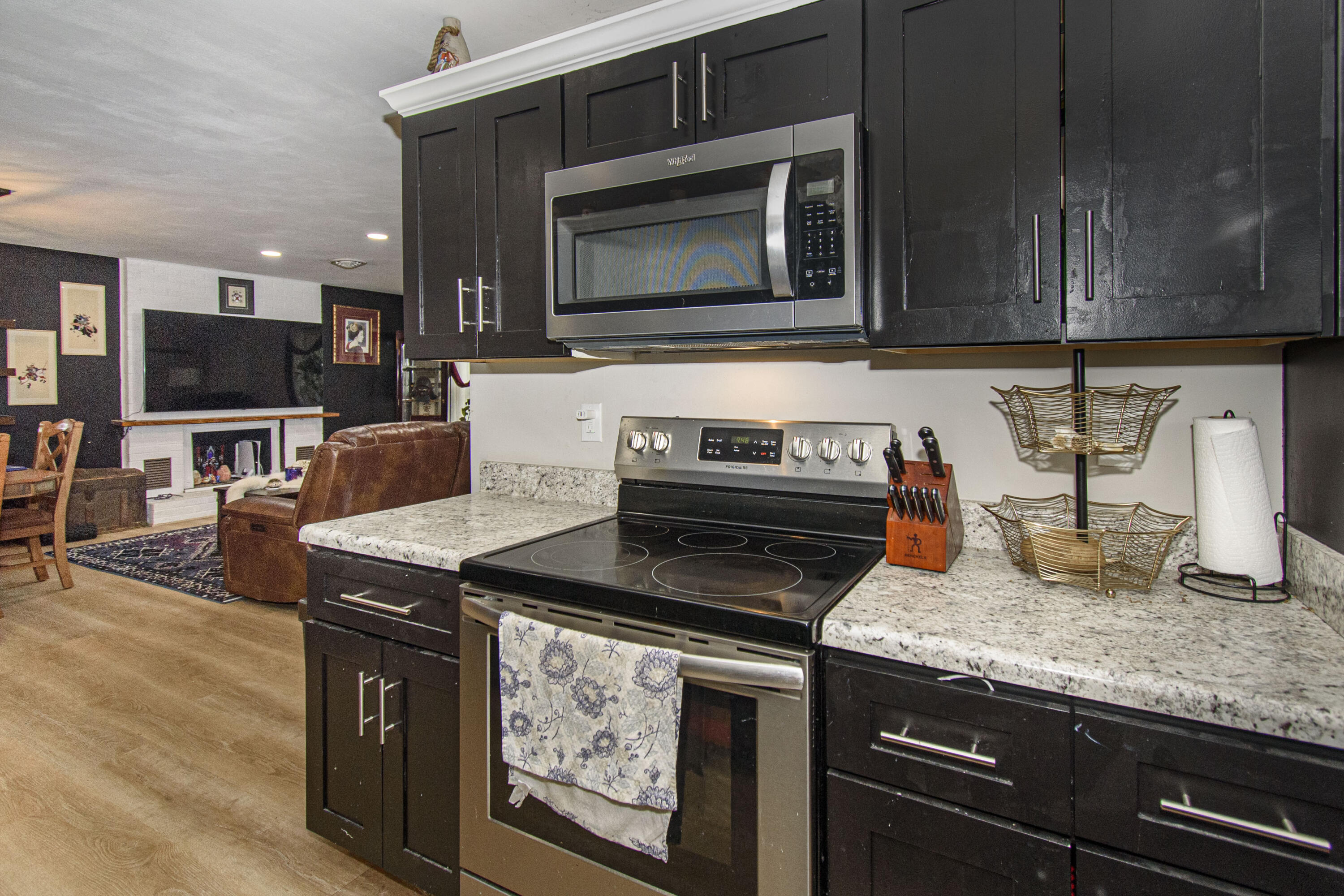 2801 Flatwoods Road Elliston, VA 24087 - Photo 11 of 56 a kitchen with granite countertop a stove top oven microwave and cabinets