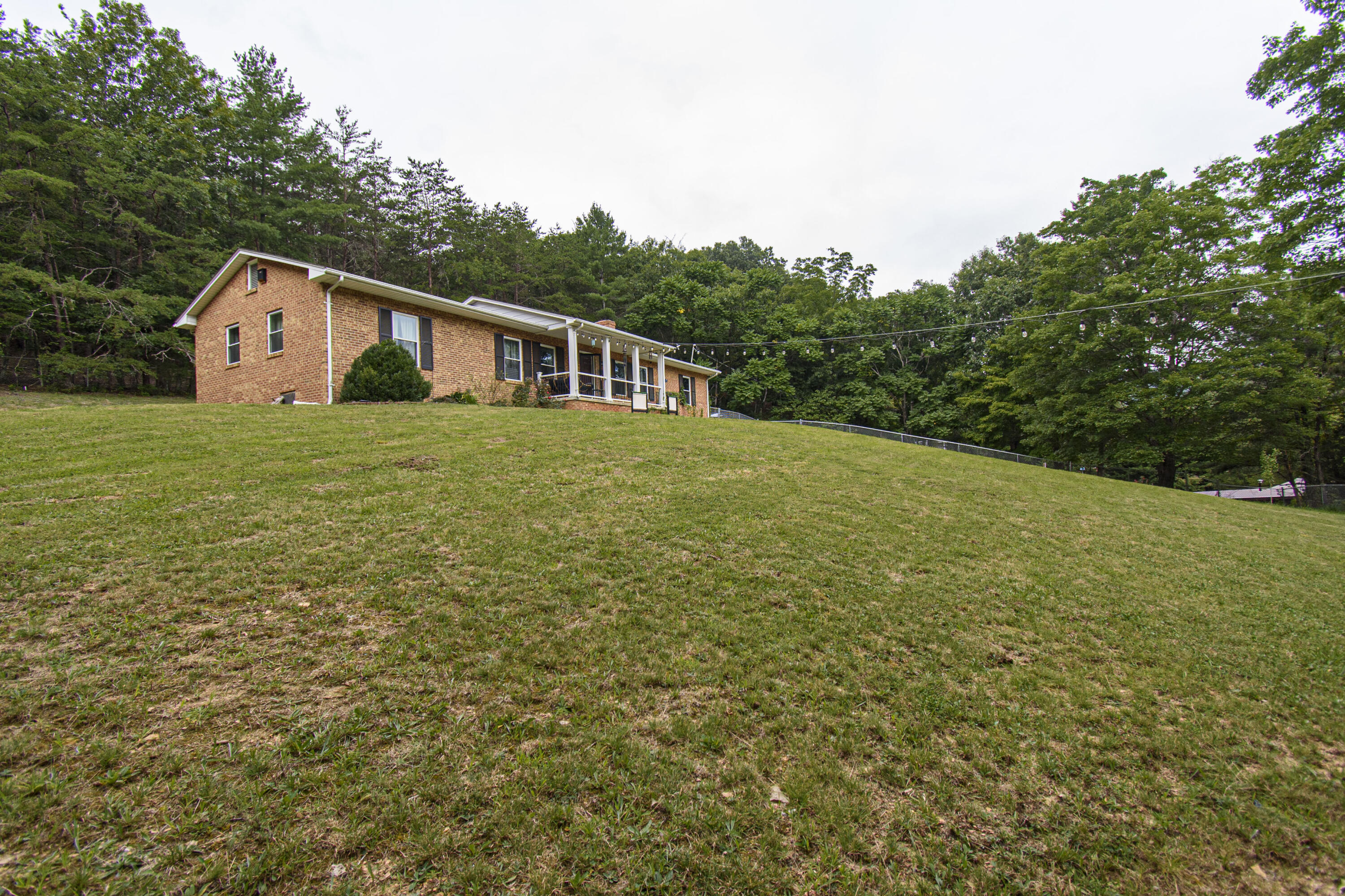 2801 Flatwoods Road Elliston, VA 24087 - Photo 36 of 56 a house with green field in front of it