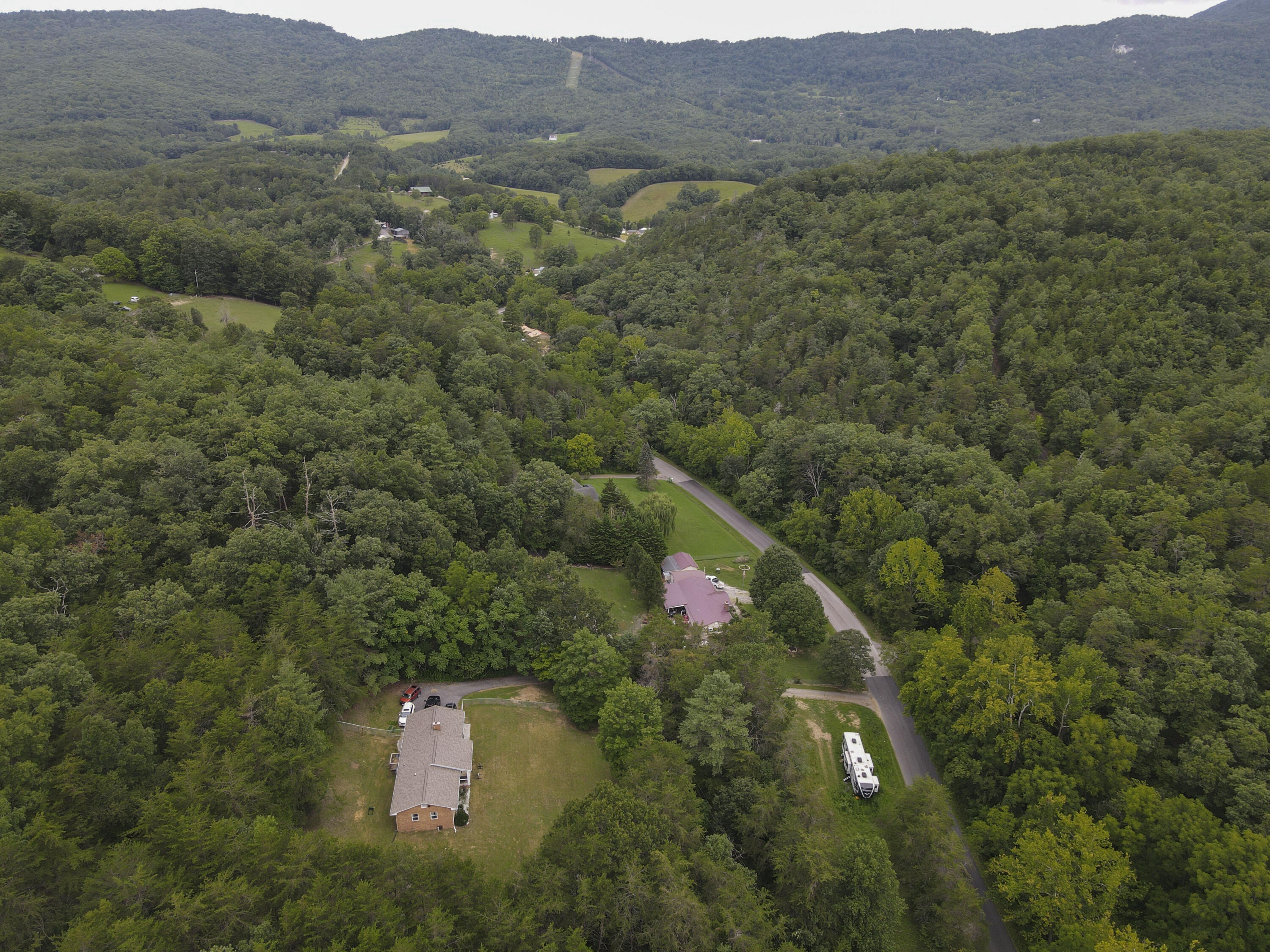 2801 Flatwoods Road Elliston, VA 24087 - Photo 54 of 56 a view of a lush green hillside and a building