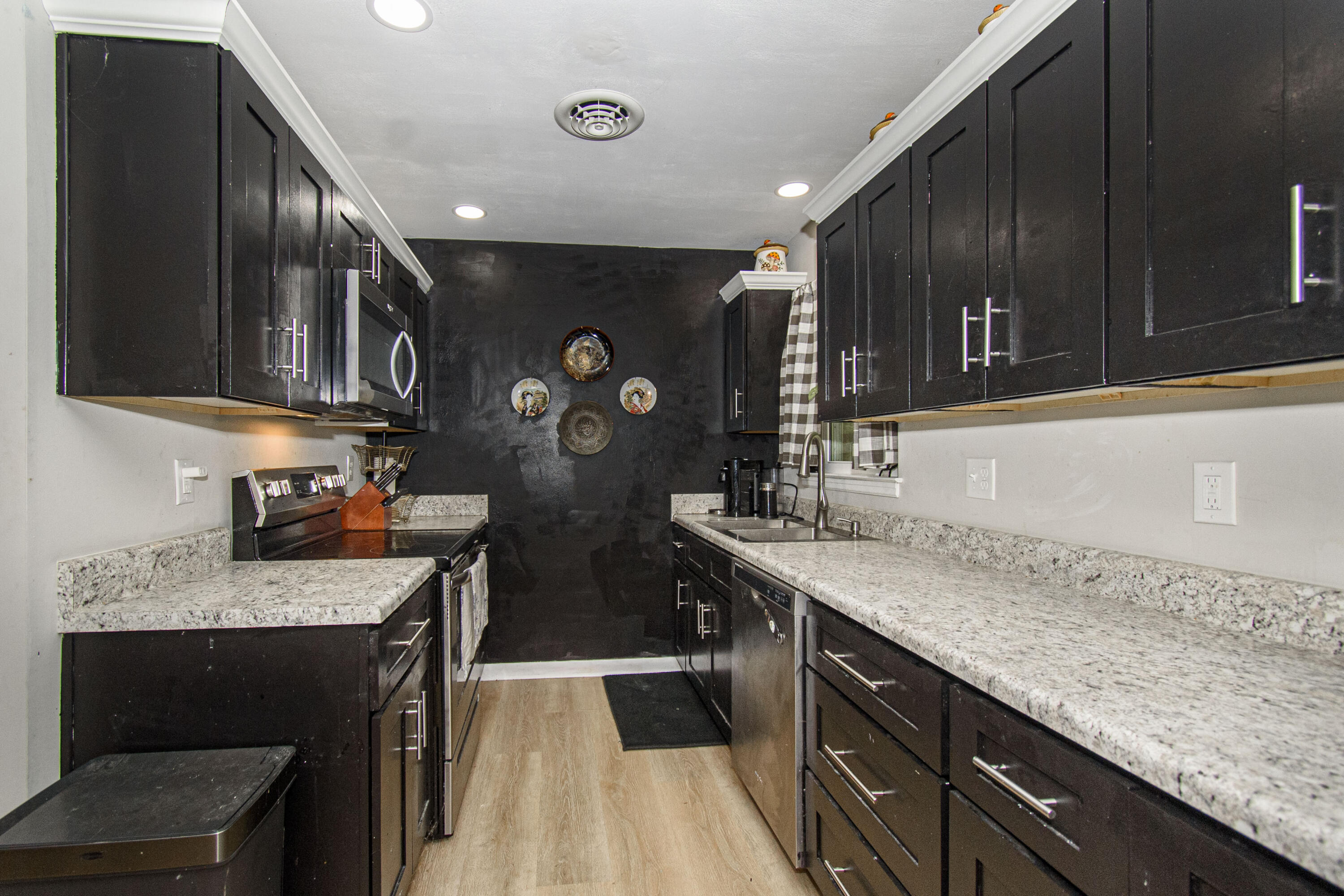 2801 Flatwoods Road Elliston, VA 24087 - Photo 8 of 56 a kitchen with stainless steel appliances granite countertop a sink stove and cabinets