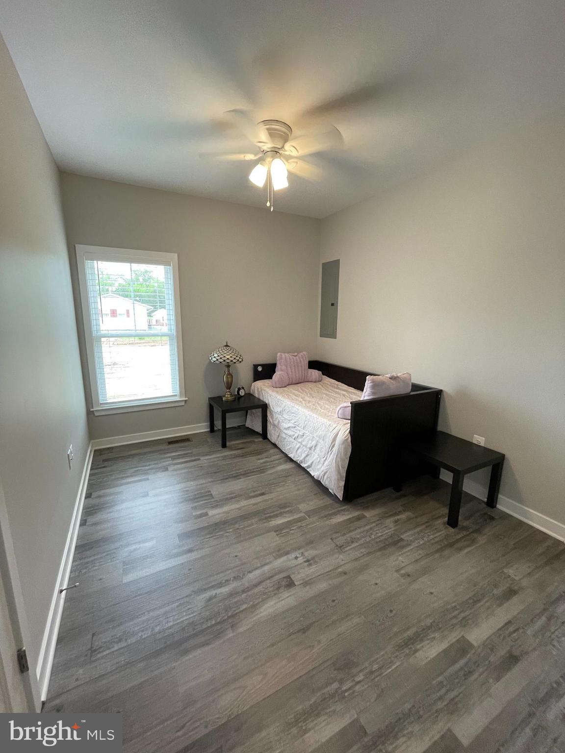 325 2nd Street Colonial Beach, VA 22443 - Photo 11 of 14 a spacious bedroom with a bed and a chandelier