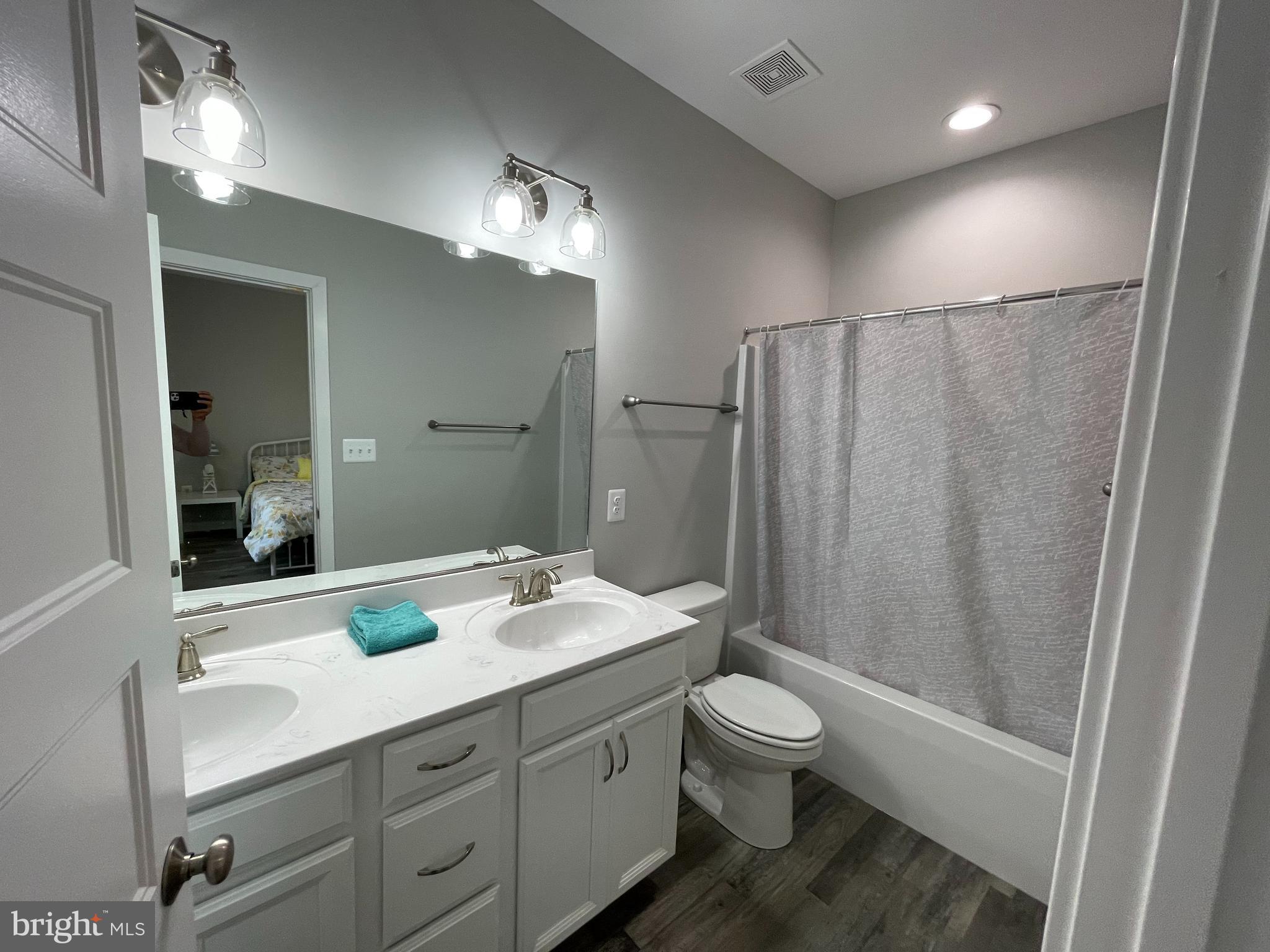 325 2nd Street Colonial Beach, VA 22443 - Photo 6 of 14 a bathroom with a double vanity sink toilet and shower