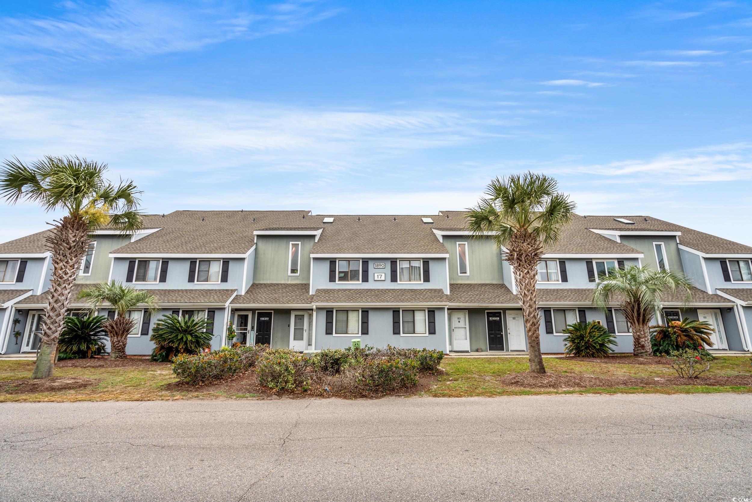 1890 Colony Drive, Unit 17L Surfside Beach, SC 29575 - Photo 1 of 38 View of front of home featuring a shingled roof and a residential view