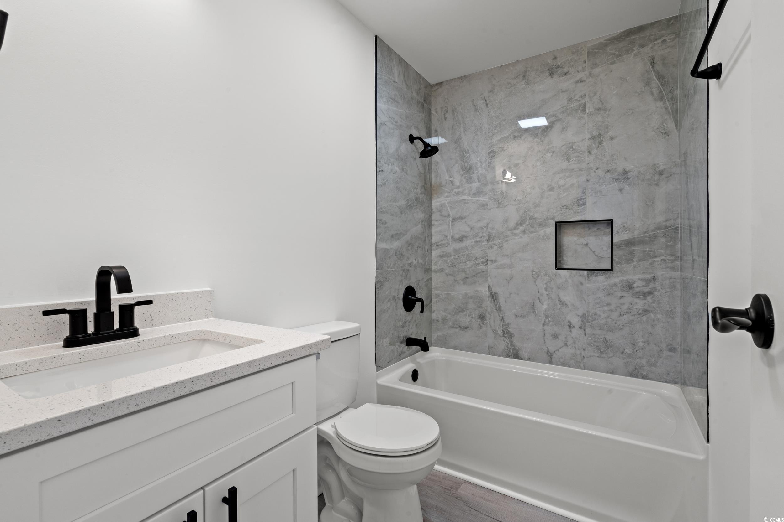 1890 Colony Drive, Unit 17L Surfside Beach, SC 29575 - Photo 21 of 38 Full bathroom with shower / washtub combination, vanity, and wood finished floors
