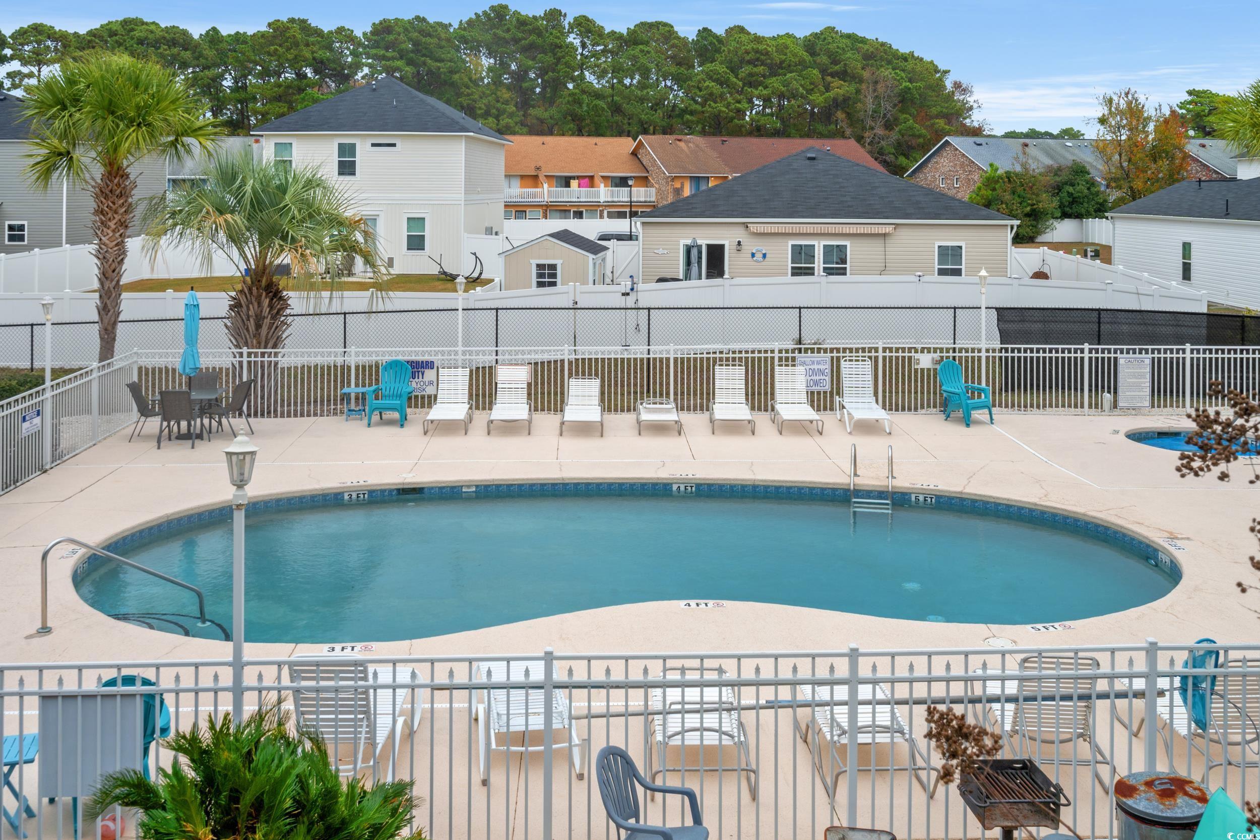 1890 Colony Drive, Unit 17L Surfside Beach, SC 29575 - Photo 35 of 38 Community pool with a patio area and a residential view