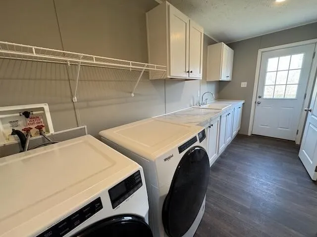 a utility room with sink dryer and washer
