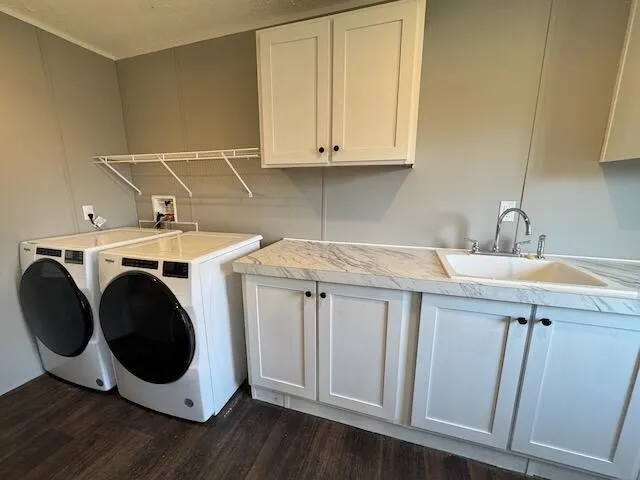 a kitchen with granite countertop white cabinets and sink