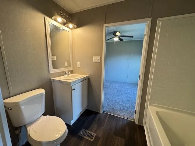 a view of empty room with window and ceiling fan