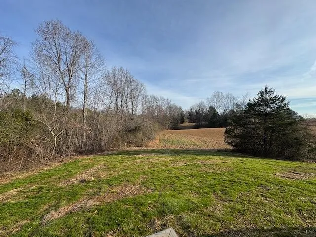 a view of a balcony with wooden floor and fence