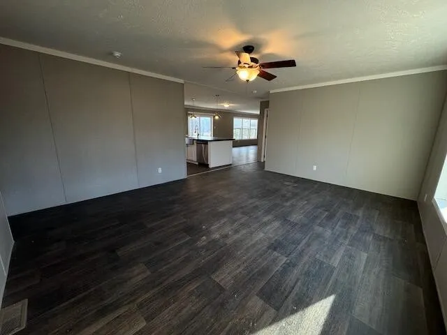 a large kitchen with stainless steel appliances kitchen island a large counter top a stove and a wooden floors