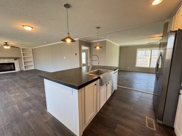 a kitchen with stainless steel appliances kitchen island granite countertop a stove a sink and a microwave