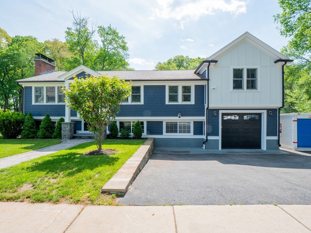 159 Mishawum Road Woburn, MA 01801 - Photo 3 of 41 a front view of a house with a yard and garage