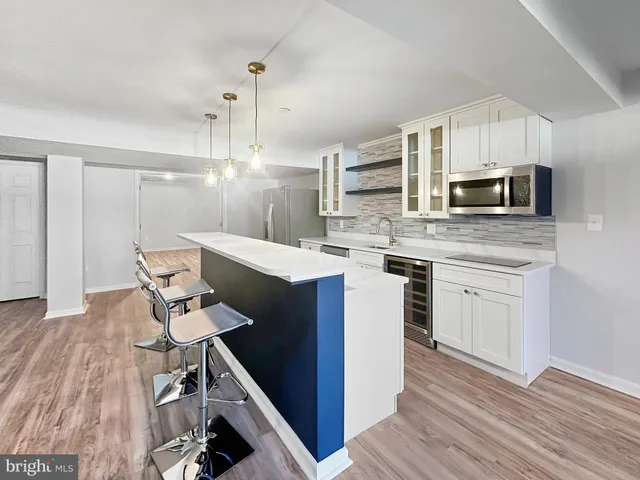 a kitchen with cabinets a sink and appliances