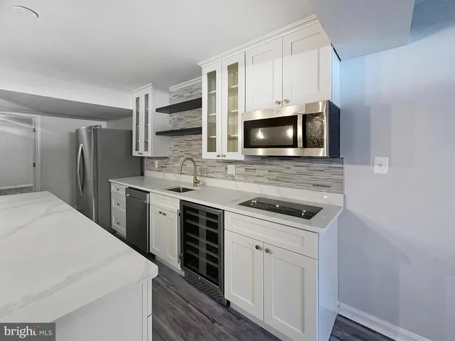 a kitchen with stainless steel appliances a stove microwave and refrigerator