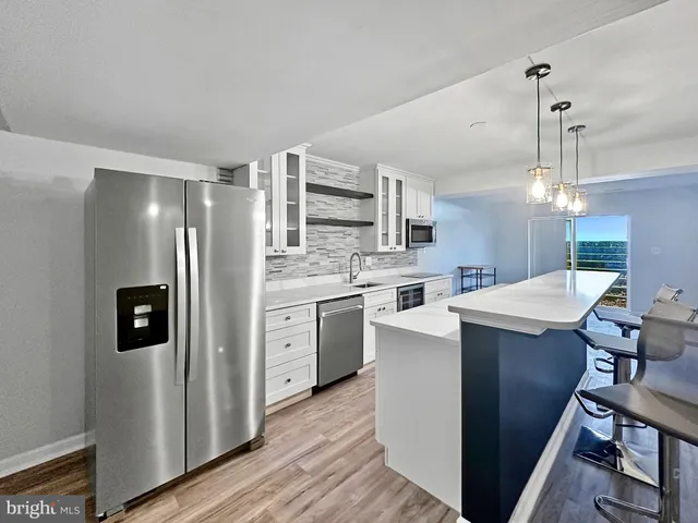 a kitchen with a sink stainless steel appliances and cabinets