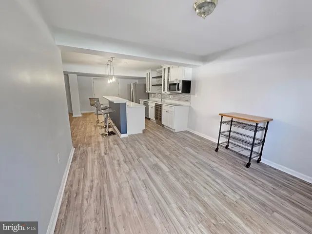 a view of kitchen with furniture and wooden floor
