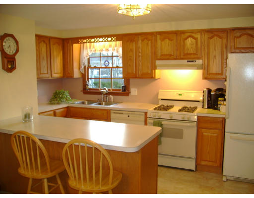 12 Plainfield Road Pepperell, MA 01463 - Photo 3 of 10 a kitchen that has a sink and a stove