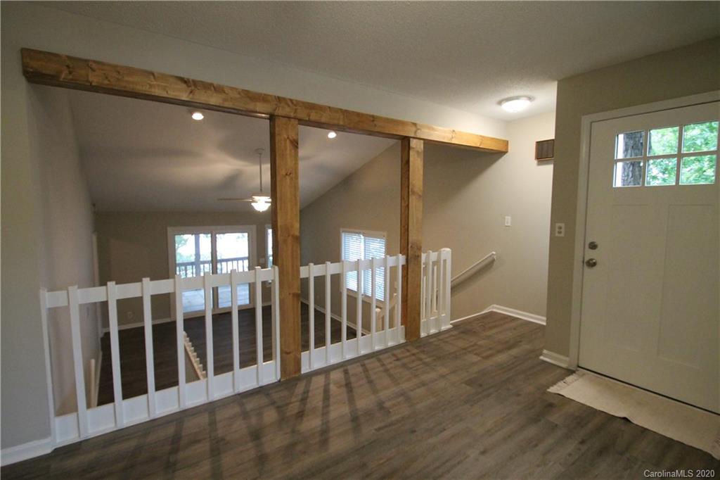 28006 Marina Drive, Unit 6 Tega Cay, SC 29708 - Photo 2 of 32 a view of a hallway with wooden floor and entryway