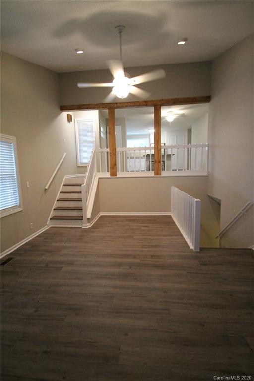 28006 Marina Drive, Unit 6 Tega Cay, SC 29708 - Photo 11 of 32 a view of an empty room with wooden floor and a window