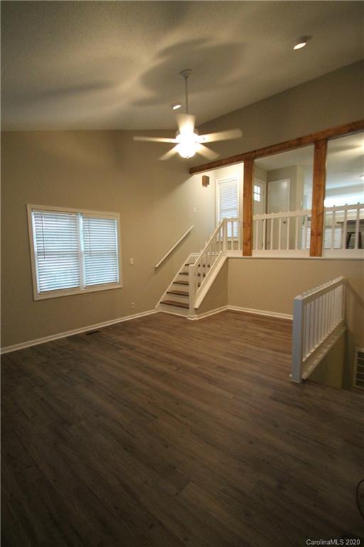28006 Marina Drive, Unit 6 Tega Cay, SC 29708 - Photo 13 of 32 a view of an empty room with window and wooden floor