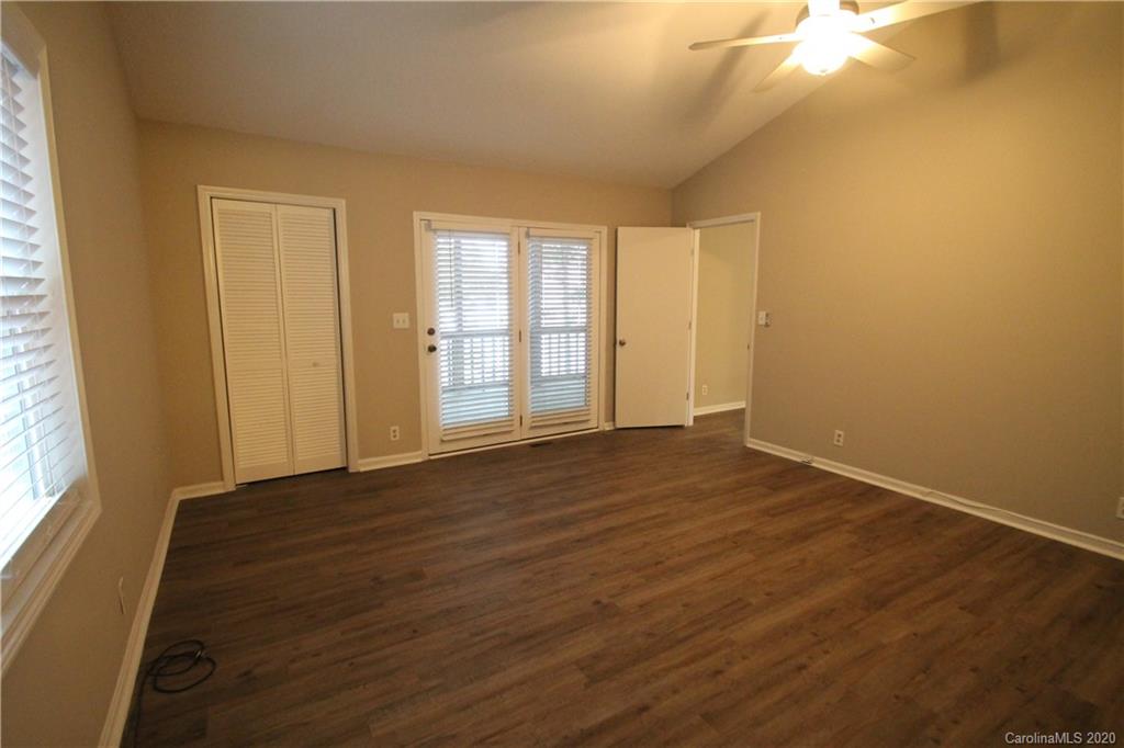28006 Marina Drive, Unit 6 Tega Cay, SC 29708 - Photo 16 of 32 a view of an empty room with wooden floor and a window