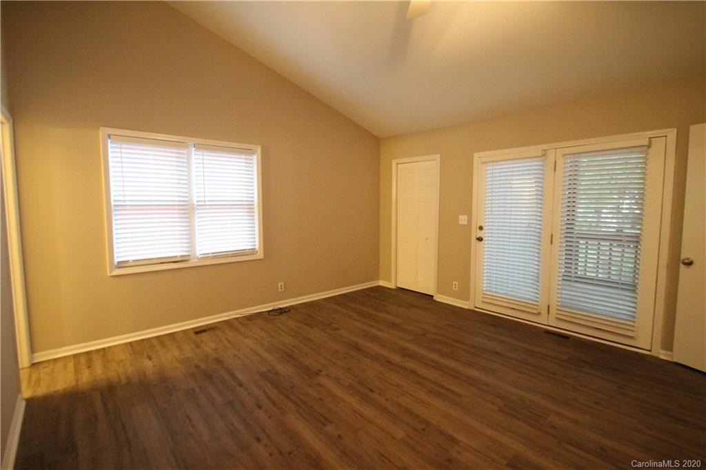 28006 Marina Drive, Unit 6 Tega Cay, SC 29708 - Photo 17 of 32 a view of an empty room with wooden floor and a window