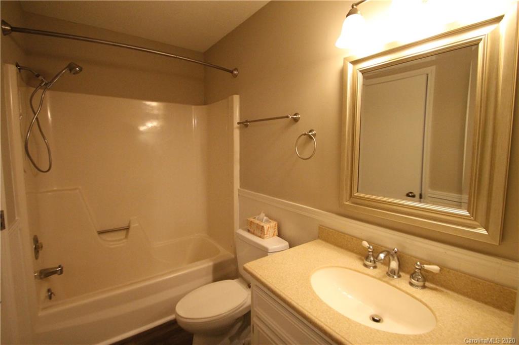 28006 Marina Drive, Unit 6 Tega Cay, SC 29708 - Photo 18 of 32 a bathroom with a sink a toilet and shower