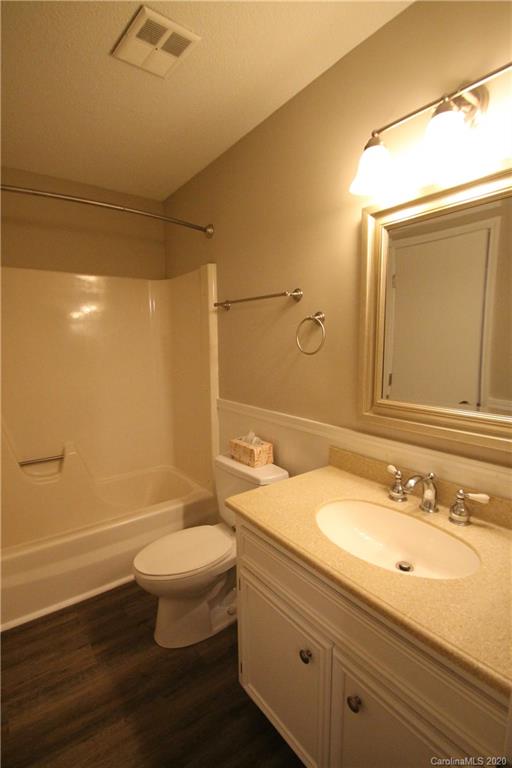 28006 Marina Drive, Unit 6 Tega Cay, SC 29708 - Photo 19 of 32 a bathroom with a sink a toilet and shower