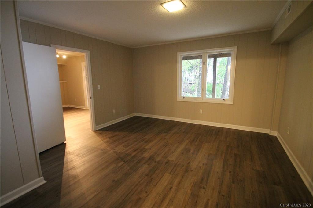 28006 Marina Drive, Unit 6 Tega Cay, SC 29708 - Photo 20 of 32 a view of an empty room with wooden floor and a window