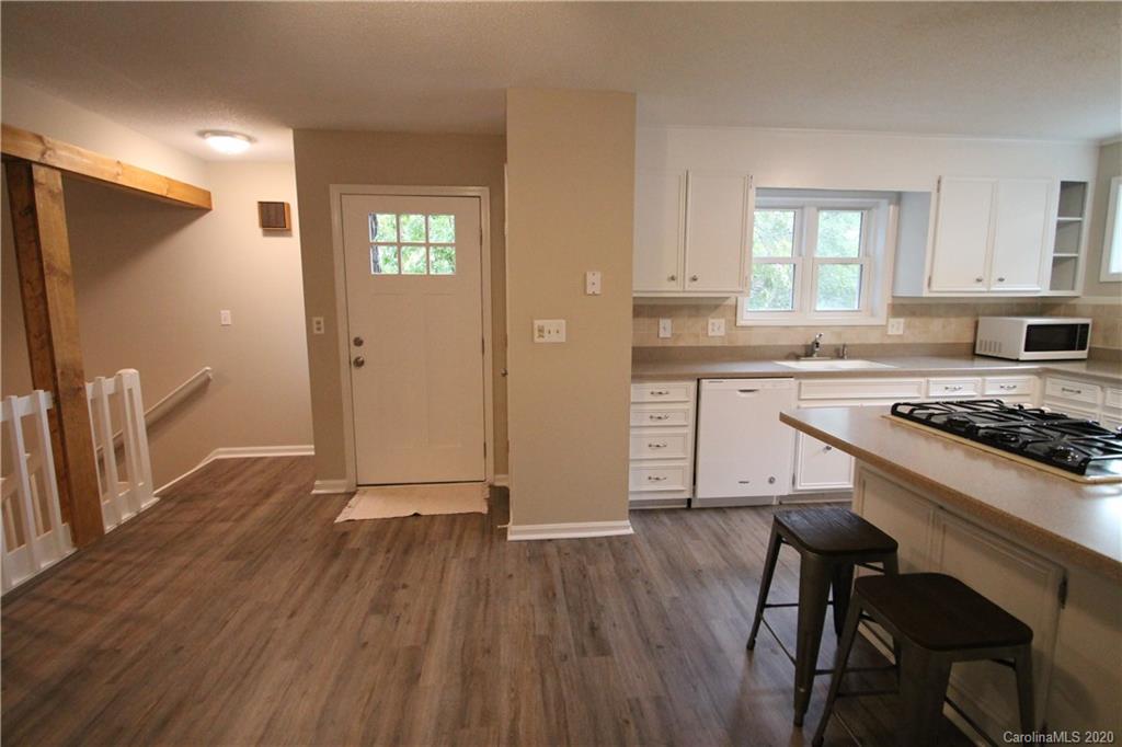 28006 Marina Drive, Unit 6 Tega Cay, SC 29708 - Photo 3 of 32 a kitchen with wooden floors and appliances