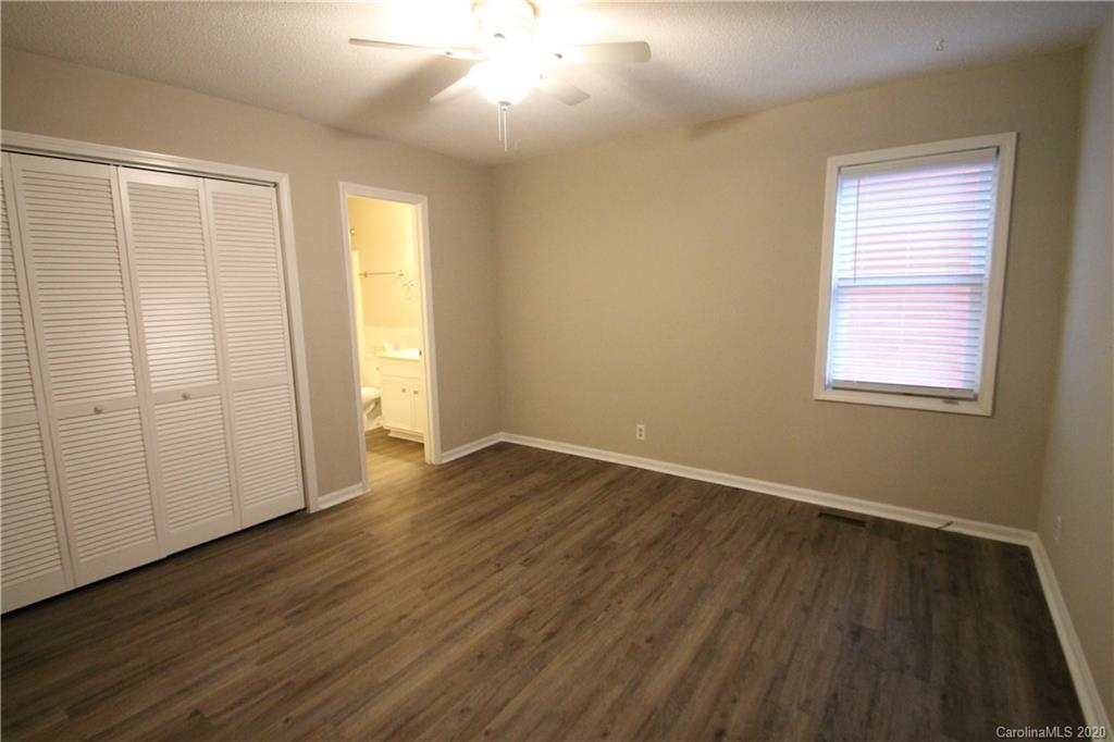 28006 Marina Drive, Unit 6 Tega Cay, SC 29708 - Photo 21 of 32 an empty room with wooden floor and windows