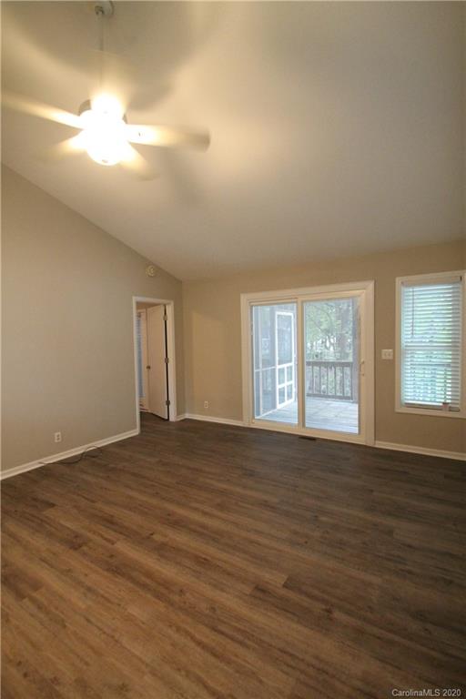 28006 Marina Drive, Unit 6 Tega Cay, SC 29708 - Photo 23 of 32 a view of an empty room with wooden floor and a window