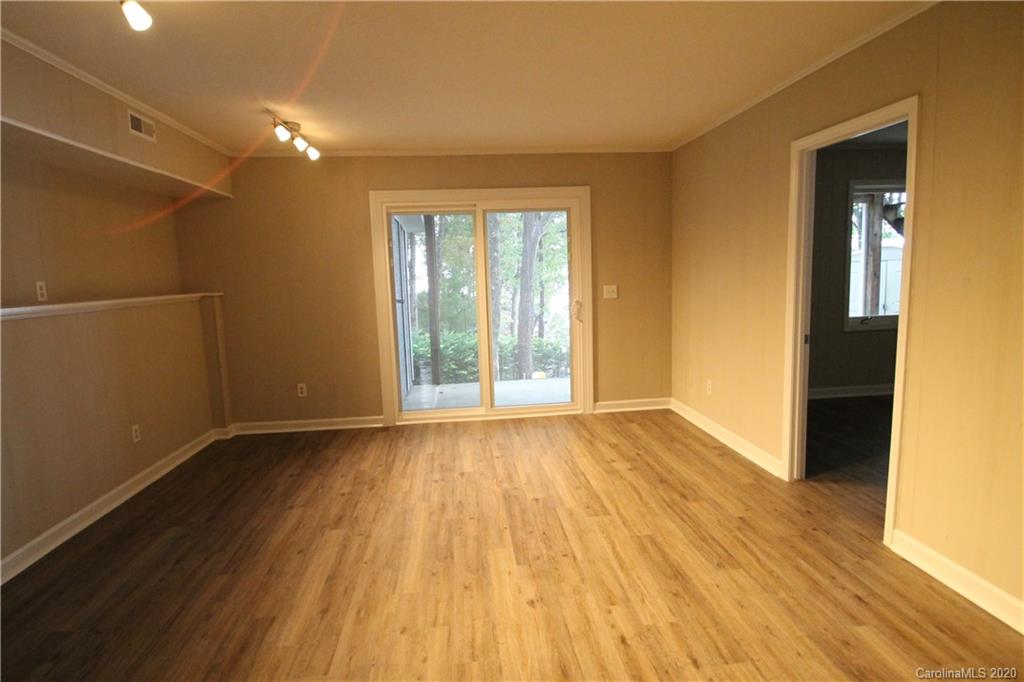 28006 Marina Drive, Unit 6 Tega Cay, SC 29708 - Photo 24 of 32 a view of an empty room with wooden floor and a window