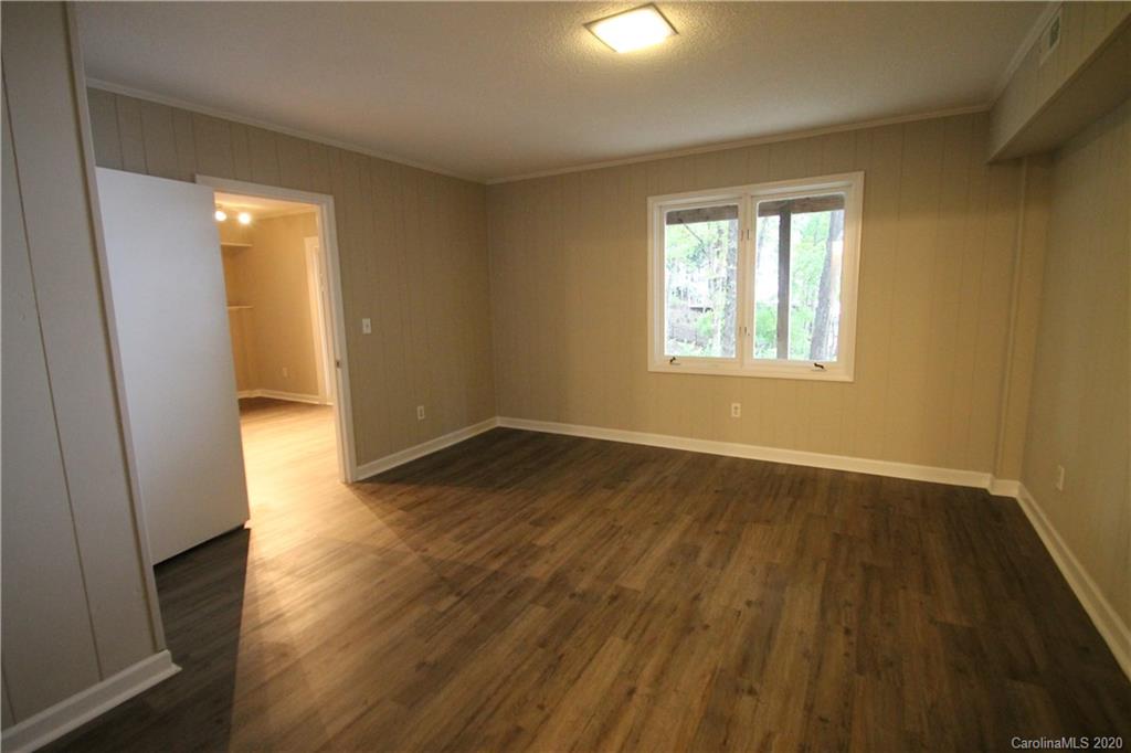28006 Marina Drive, Unit 6 Tega Cay, SC 29708 - Photo 25 of 32 a view of an empty room with wooden floor and a window