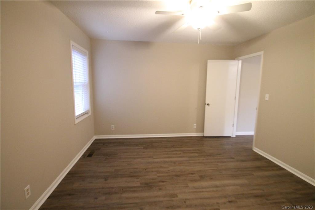 28006 Marina Drive, Unit 6 Tega Cay, SC 29708 - Photo 27 of 32 a view of an empty room with wooden floor and window