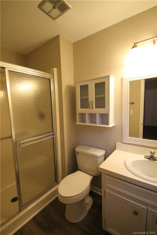 28006 Marina Drive, Unit 6 Tega Cay, SC 29708 - Photo 28 of 32 a bathroom with a sink a mirror and a toilet
