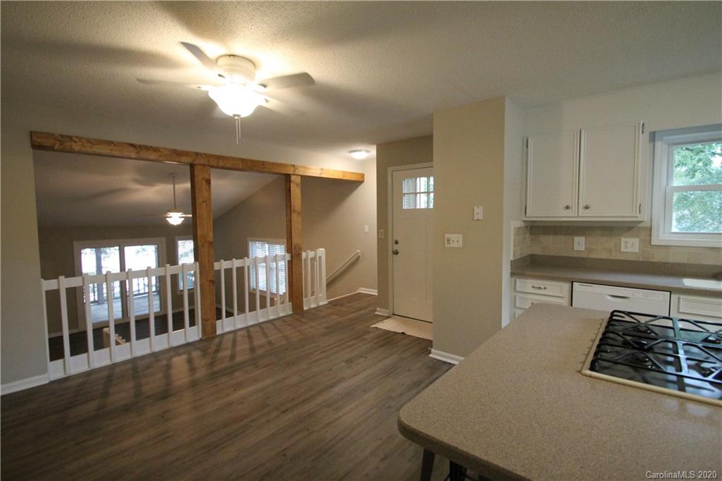 28006 Marina Drive, Unit 6 Tega Cay, SC 29708 - Photo 5 of 32 a kitchen with stainless steel appliances granite countertop a refrigerator a stove and a wooden floors
