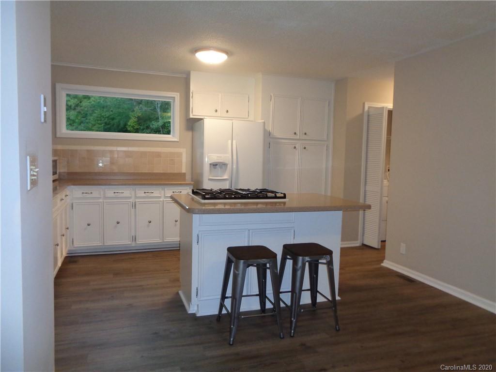 28006 Marina Drive, Unit 6 Tega Cay, SC 29708 - Photo 6 of 32 a view of kitchen with granite countertop window and wooden floor