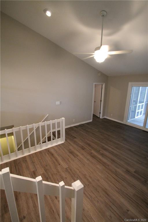 28006 Marina Drive, Unit 6 Tega Cay, SC 29708 - Photo 7 of 32 a view of an empty room with wooden floor and a window